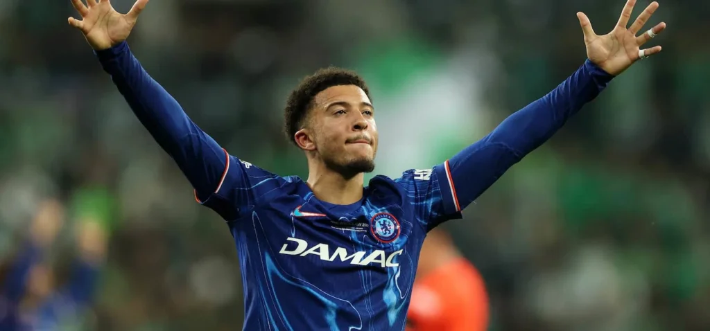 Jadon Sancho celebrates after scoring in a recent match amid transfer speculation.